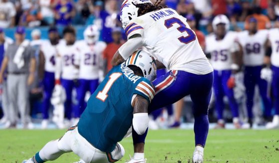 Tua Tagovailoa of the Miami Dolphins, left, collides with Damar Hamlin of the Buffalo Bills, right, during the third quarter in the game in Miami Gardens, Florida, on Thursday.