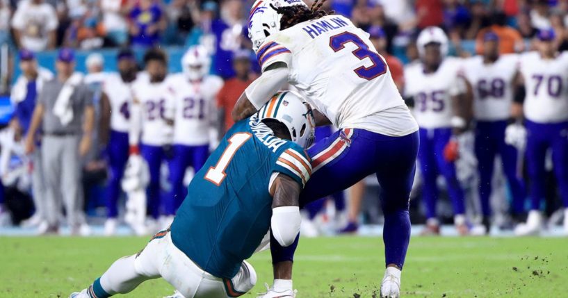 Tua Tagovailoa of the Miami Dolphins, left, collides with Damar Hamlin of the Buffalo Bills, right, during the third quarter in the game in Miami Gardens, Florida, on Thursday.