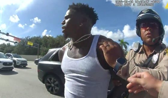 A police officer handcuffs the NFL's No.1 player Tyreek Hill of the Miami Dolphins shortly before Sunday's game.