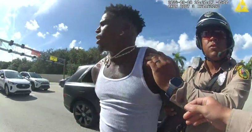 A police officer handcuffs the NFL's No.1 player Tyreek Hill of the Miami Dolphins shortly before Sunday's game.