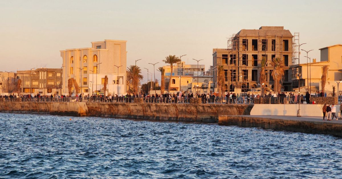 People walk at the seaside promenade in the Gargaresh district of the Libyan capital Tripoli on January 26, 2024.