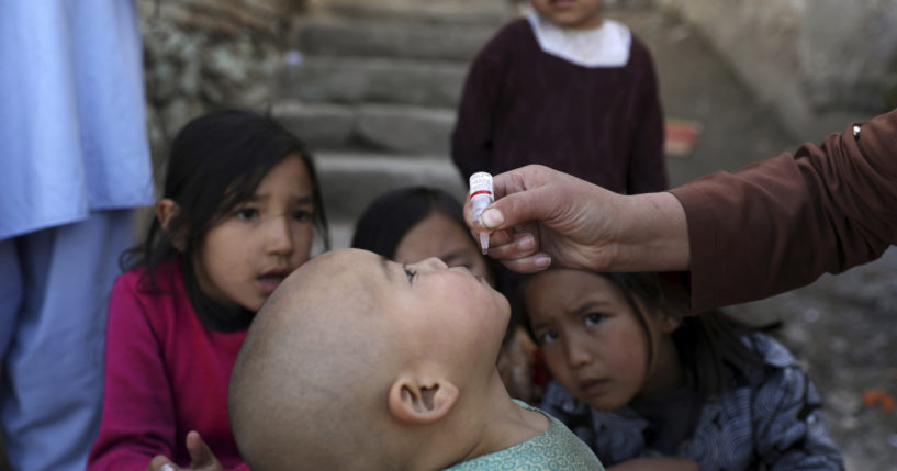 Shabana Maani, gives a polio vaccination to a child in the old part of Kabul, Afghanistan, Monday, March 29, 2021.