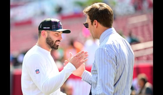 Baker Mayfield #6 of the Tampa Bay Buccaneers and former NFL player Tom Brady embrace prior to a game against the Philadelphia Eagles at Raymond James Stadium on September 29, 2024 in Tampa, Florida.