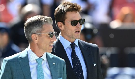 Broadcasters Kevin Burkhardt (L) and Tom Brady (R) walk along the field before the game between the Dallas Cowboys and Cleveland Browns at Cleveland Browns Stadium on September 8, 2024 in Cleveland, Ohio.