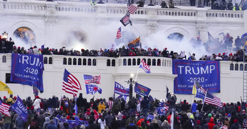 Rioters at the U.S. Capitol on January 6, 2021, in Washington. A former Virginia police officer who stormed the U.S. Capitol has received a reduced prison sentence of six years. Former Rocky Mount Police Sgt. Thomas Robertson's re-sentencing on Wednesday makes him one of the first beneficiaries of a recent U.S. Supreme Court ruling that limited the government’s use of a federal obstruction law.