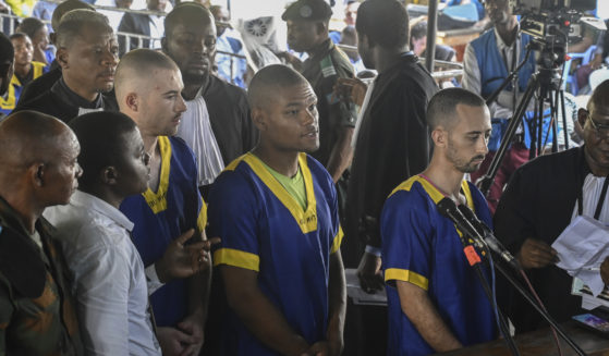 From left T,yler Thompson Jr, Marcel Malanga and Benjamin Reuben Zalman-Polun, all American citizens, face the court in Kinshasa with 52 other defendants on June 7.