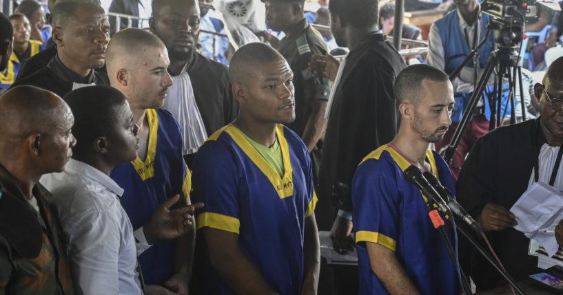 From left T,yler Thompson Jr, Marcel Malanga and Benjamin Reuben Zalman-Polun, all American citizens, face the court in Kinshasa with 52 other defendants on June 7.