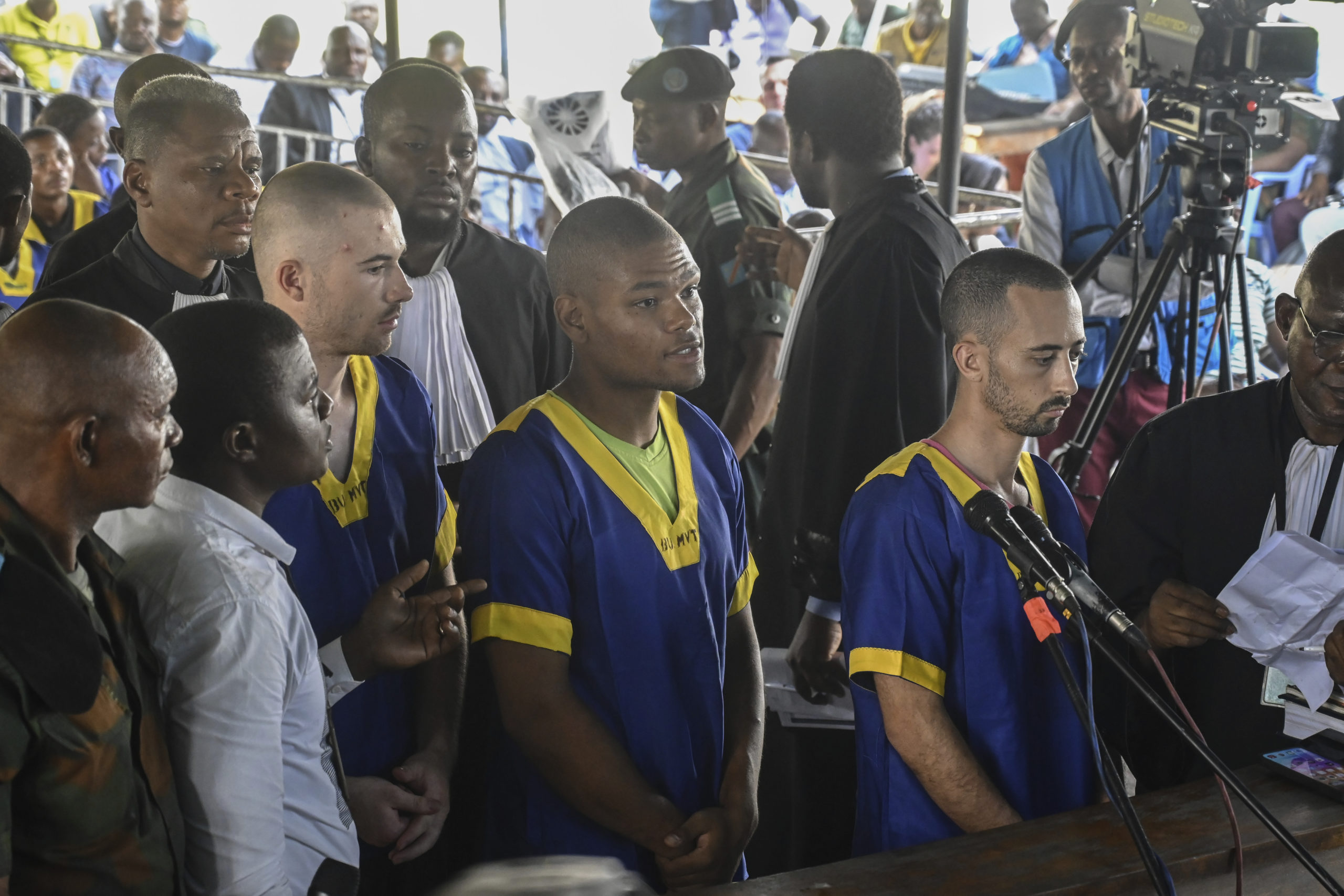 From left T,yler Thompson Jr, Marcel Malanga and Benjamin Reuben Zalman-Polun, all American citizens, face the court in Kinshasa with 52 other defendants on June 7.