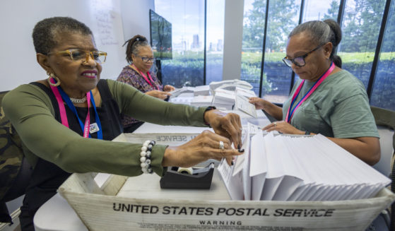 Carol Hamilton, left, Cristo Carter, middle, and Cynthia Huntley, right, prepare ballots to be mailed at the Mecklenburg County Board of Elections in Charlotte, North Carolina, on Sept. 5.