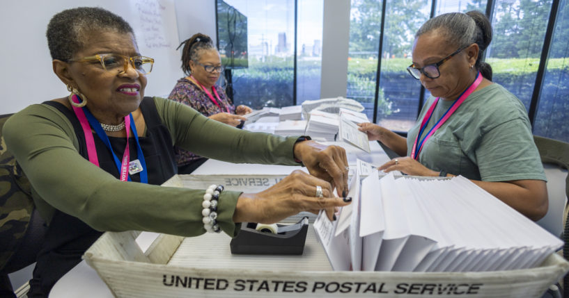 Carol Hamilton, left, Cristo Carter, middle, and Cynthia Huntley, right, prepare ballots to be mailed at the Mecklenburg County Board of Elections in Charlotte, North Carolina, on Sept. 5.