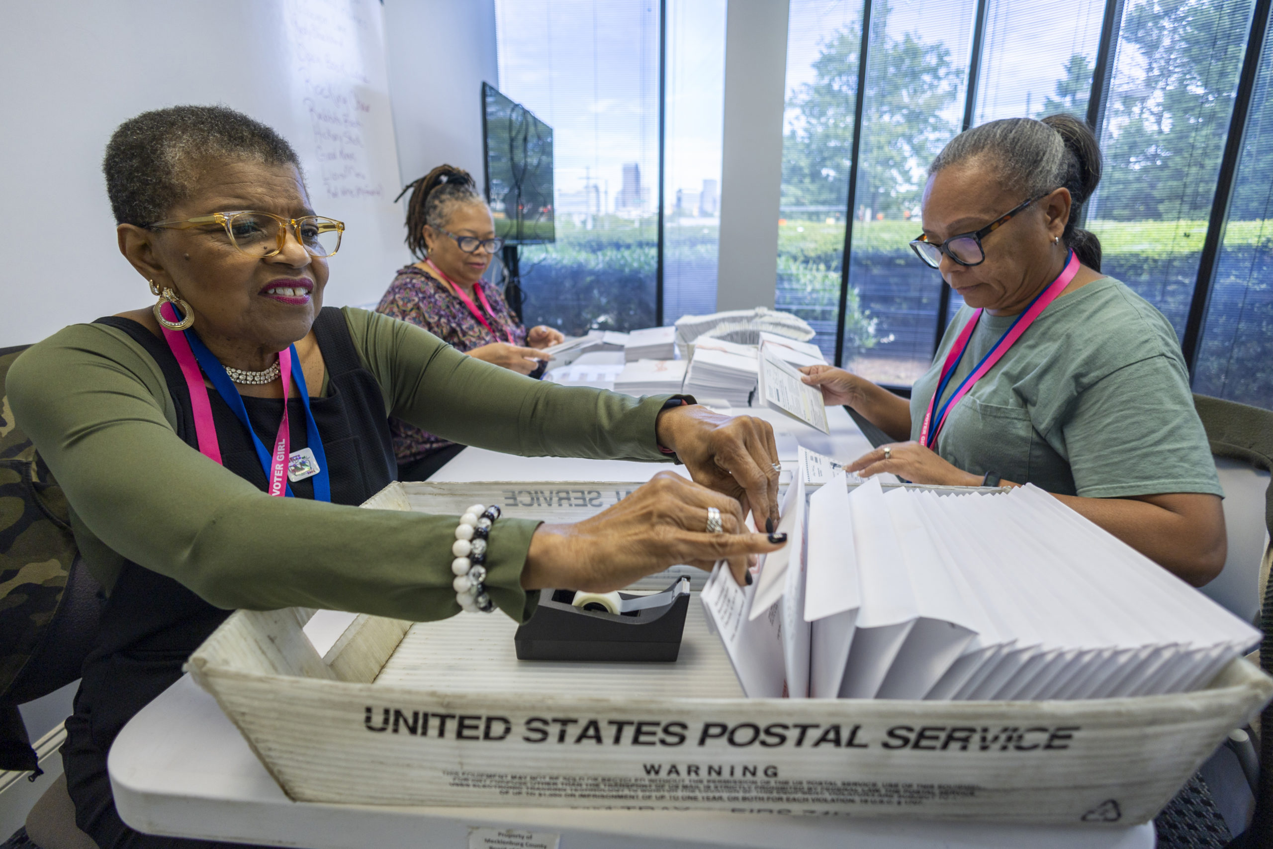 Carol Hamilton, left, Cristo Carter, middle, and Cynthia Huntley, right, prepare ballots to be mailed at the Mecklenburg County Board of Elections in Charlotte, North Carolina, on Sept. 5.