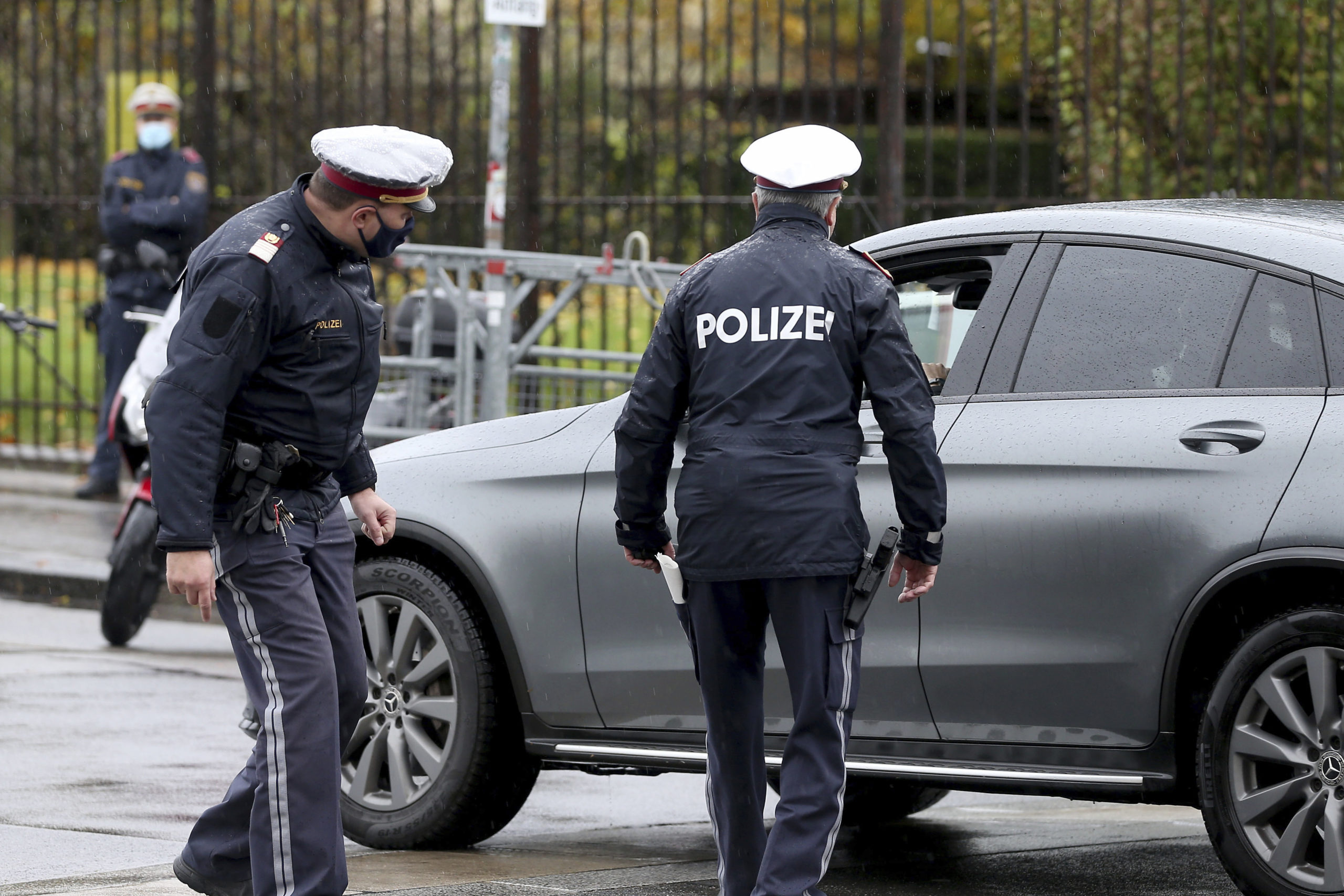 Police officers check a car in downtown Vienna, Austria, on Oct. 30, 2020.