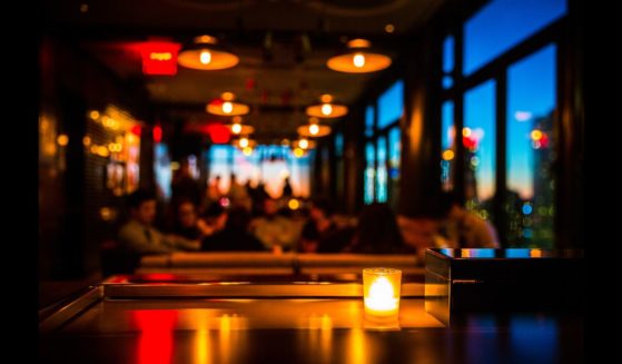 This Getty stock image shows a restaurant, with a tabletop candle in the foreground.