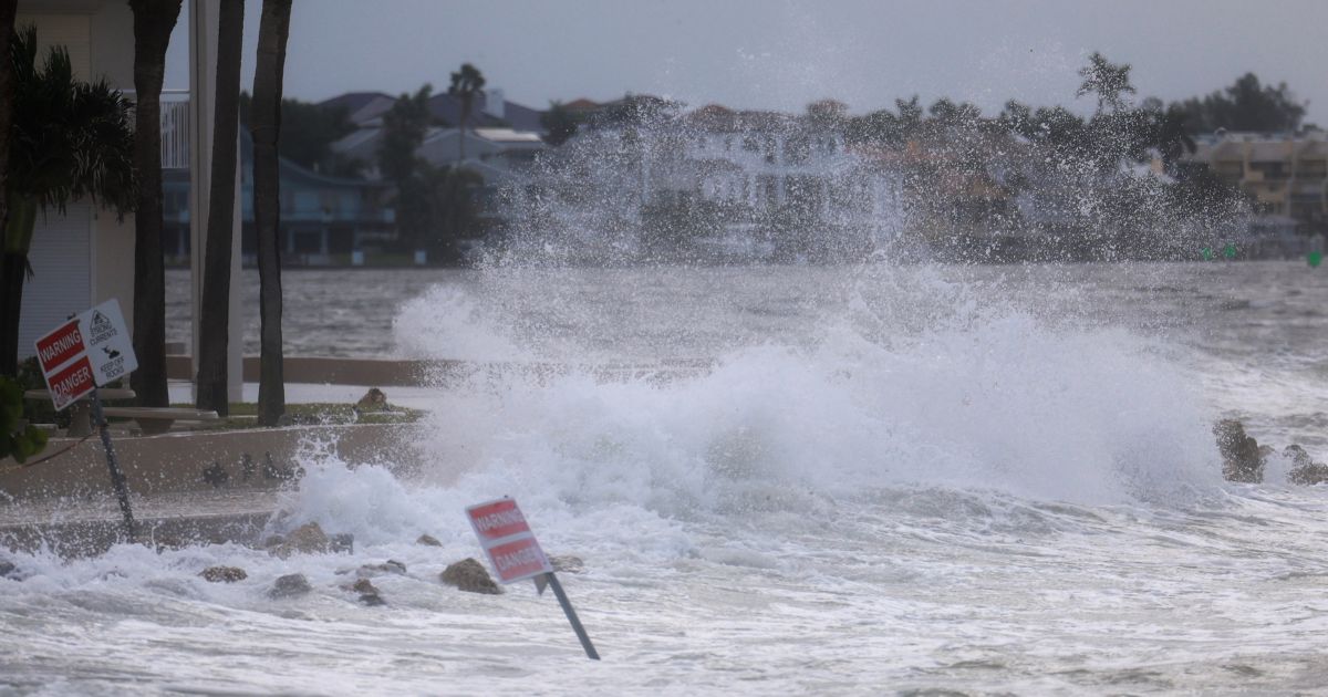 Waves from the Gulf of Mexico crash on shore as Hurricane Helene churns offshore on September 26, 2024 in St. Pete Beach, Florida.