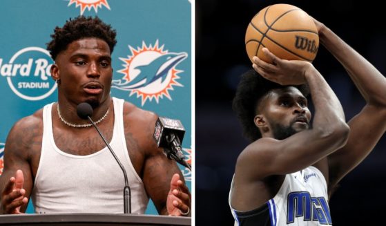 (L) Wide Receiver Tyreek Hill #10 of the Miami Dolphins addresses the media during the post-game press conference after playing the Jacksonville Jaguars at Hard Rock Stadium on September 8, 2024 in Miami Gardens, Florida. (R) Jonathan Isaac #1 of the Orlando Magic shoots a free throw during the second half of an NBA game against the Charlotte Hornets at Spectrum Center on March 5, 2024 in Charlotte, North Carolina.