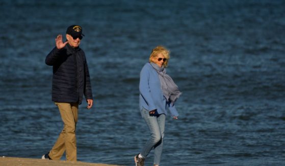 US President Joe Biden and First Lady Jill Biden walk on the beach in Rehoboth Beach, Delaware, on October 22, 2023.