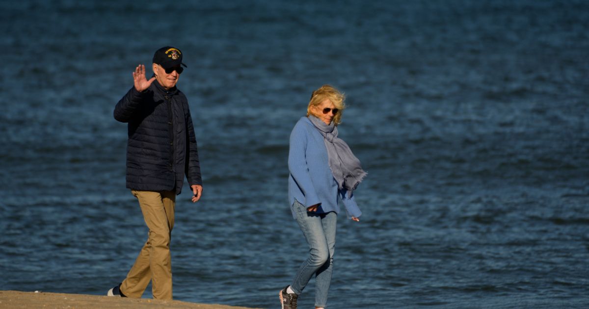 US President Joe Biden and First Lady Jill Biden walk on the beach in Rehoboth Beach, Delaware, on October 22, 2023.