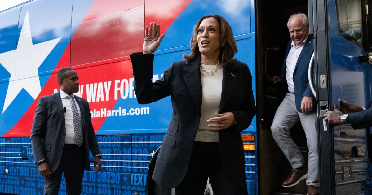 Democratic presidential candidate US Vice President Kamala Harris and her running mate, Minnesota Governor Tim Walz, disembark from their campaign bus in Savannah, Georgia, August 28, 2024, as they travel across Georgia for a 2-day campaign bus tour.