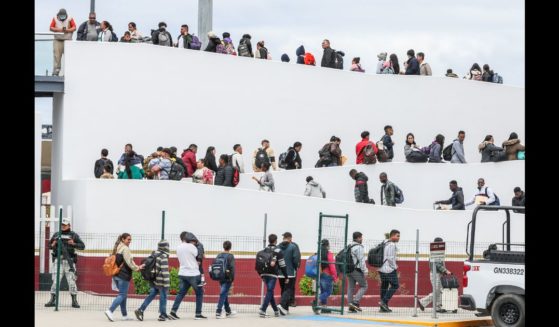 Hundreds of asylum seekers who used a CBP phone app to make an appointment, are led to their interviews with U.S. customs agents at the San Ysidro Border Crossing.