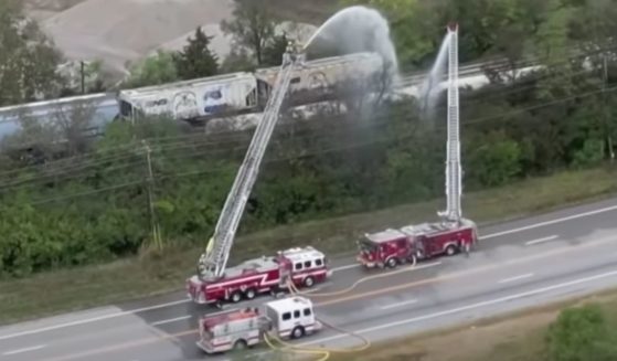 This YouTube screen shot shows first responders cooling off a new train derailment in Ohio that is leaking dangerous chemicals.