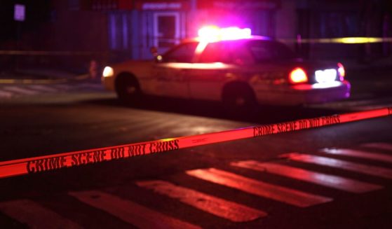 This Getty stock image shows a police scene, including tape and a squad car.