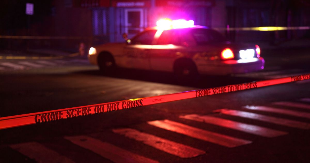 This Getty stock image shows a police scene, including tape and a squad car.