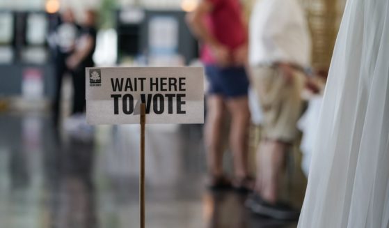 A 'Wait Here To Vote' sign is seen in a polling location as voters check in to cast ballots on May 21, 2024 in Atlanta, Georgia.