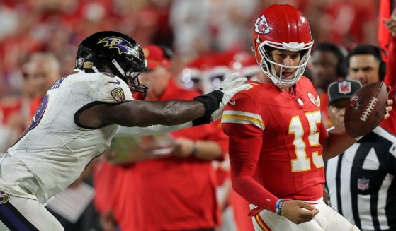 Roquan Smith #0 of the Baltimore Ravens has a late hit on quarterback Patrick Mahomes #15 of the Kansas City Chiefs during the fourth quarter at GEHA Field at Arrowhead Stadium on September 05, 2024 in Kansas City, Missouri.