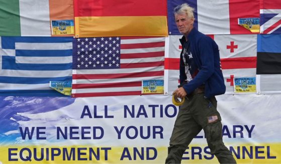 This photograph taken on Independence Square in Kyiv on June 23, 2022 shows US citizen Ryan Wesley Routh sticking up national flags of the countries helping Ukraine.