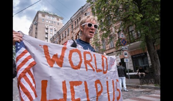 A man holds banner and shouts slogans during a demonstration in support of Mariupol defenders on May 3, 2022 in Kyiv, Ukraine.