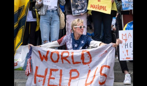 Ryan Routh holds a banner during a demonstration in support of Mariupol defenders on May 3, 2022 in Kyiv, Ukraine.