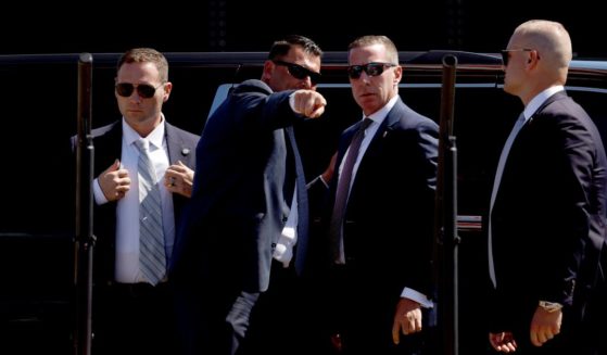 U.S. Secret Service officers look at the stage before the arrival of Republican presidential candidate former U.S. President Donald Trump at a campaign rally at the Aero Center Wilmington on September 21, 2024 in Wilmington, North Carolina.