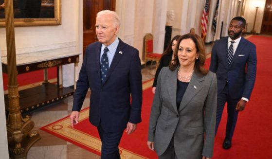 US President Joe Biden and US Vice President Kamala Harris walk to an event on gun violence in the East Room of the White House in Washington, DC on September 26, 2024.