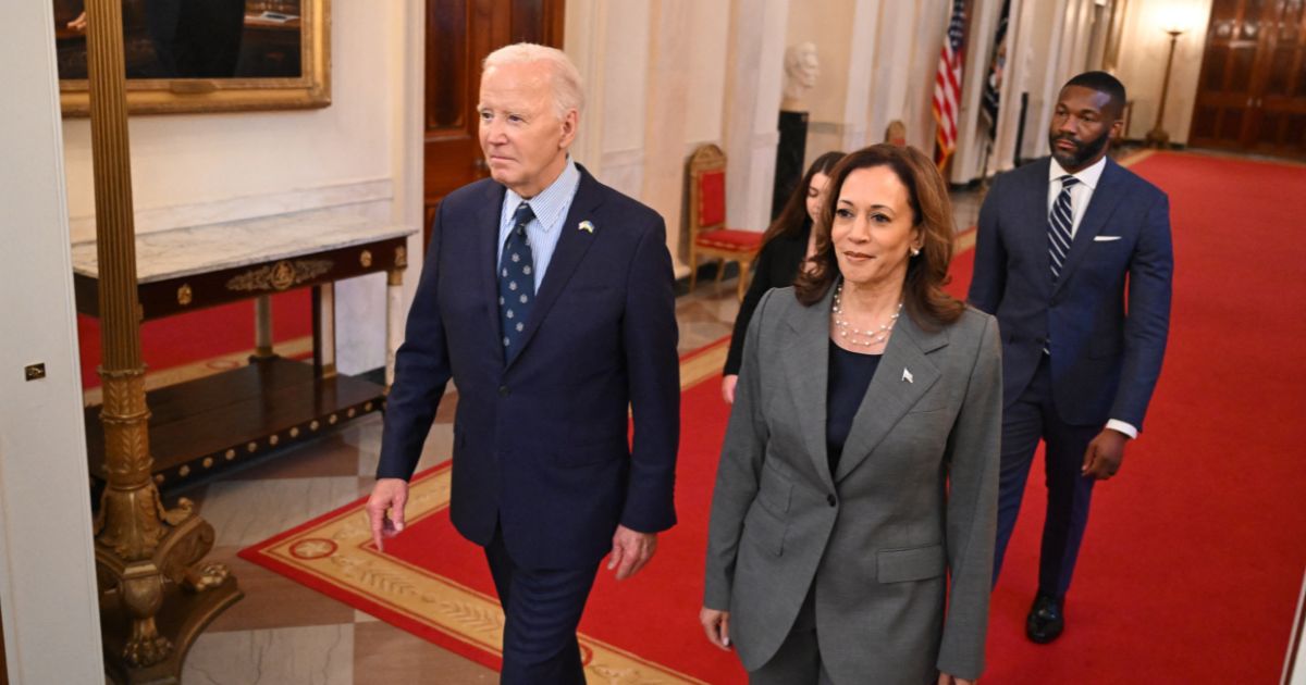 US President Joe Biden and US Vice President Kamala Harris walk to an event on gun violence in the East Room of the White House in Washington, DC on September 26, 2024.