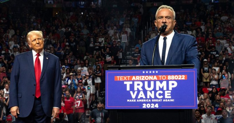 Former presidential candidate Robert F. Kennedy Jr. (R) speaks as Republican presidential nominee, former U.S. President Donald Trump listens during a campaign rally at Desert Diamond Arena on August 23, 2024 in Glendale, Arizona.