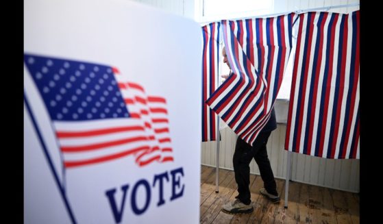 A voter prepares to leave a voting booth as they take part in the New Hampshire primary at Sanbornton Old Town Hall on Tuesday January 23, 2024 in Sanbornton, NH.