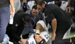 Detroit Lions defensive end Aidan Hutchinson is attended to by team staff after suffering a broken tibia in the second half of an NFL football game against the Dallas Cowboys in Arlington, Texas, on Sunday.