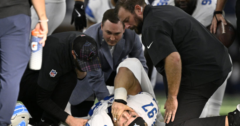 Detroit Lions defensive end Aidan Hutchinson is attended to by team staff after suffering a broken tibia in the second half of an NFL football game against the Dallas Cowboys in Arlington, Texas, on Sunday.