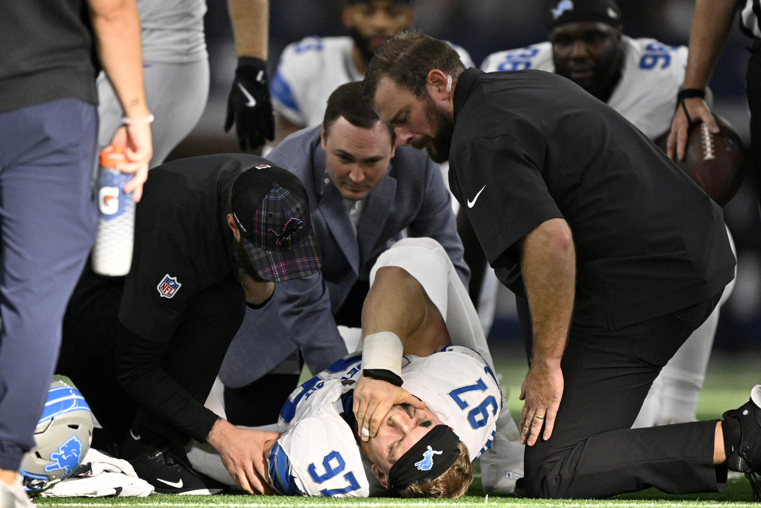 Detroit Lions defensive end Aidan Hutchinson is attended to by team staff after suffering a broken tibia in the second half of an NFL football game against the Dallas Cowboys in Arlington, Texas, on Sunday.