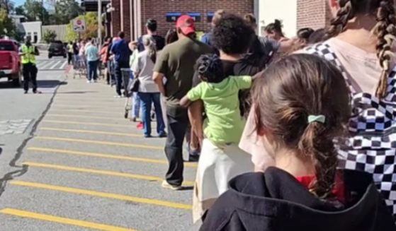 People in Asheville, North Carolina, wait outside of a Walmart in order to get supplies, but once inside, video showed that the shelves were empty.