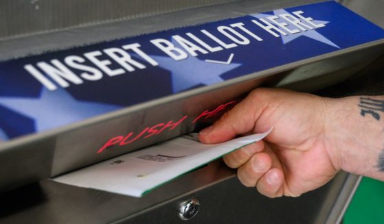 A voter uses a ballot drop box at the Bucks County Administration building in Doylestown, Pennsylvania, on Thursday.