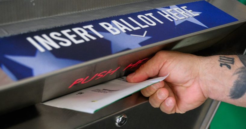 A voter uses a ballot drop box at the Bucks County Administration building in Doylestown, Pennsylvania, on Thursday.