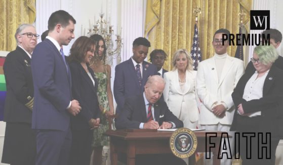 President Joe Biden signs an executive order for equality for LGBT individuals as Transportation Secretary Pete Buttigieg, second from left, Vice President Kamala Harris, third from left, first lady Jill Biden, third from right, Javier Gomez, second from right, and other LGBT advocates look on during a pride event at the East Room of the White House in Washington, D.C., on June 15, 2022.