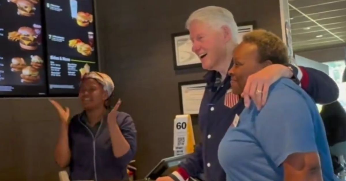 Former President Bill Clinton poses with employees at a Georgia McDonald's.