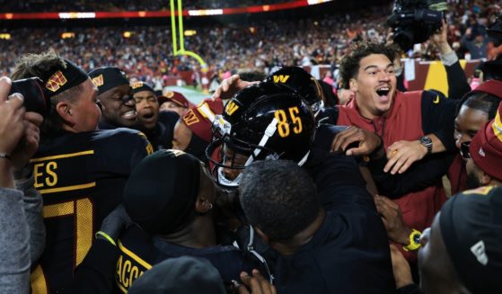 Noah Brown of the Washington Commanders celebrates his game-winning touchdown reception against the Chicago Bears in Landover, Maryland, on Sunday.