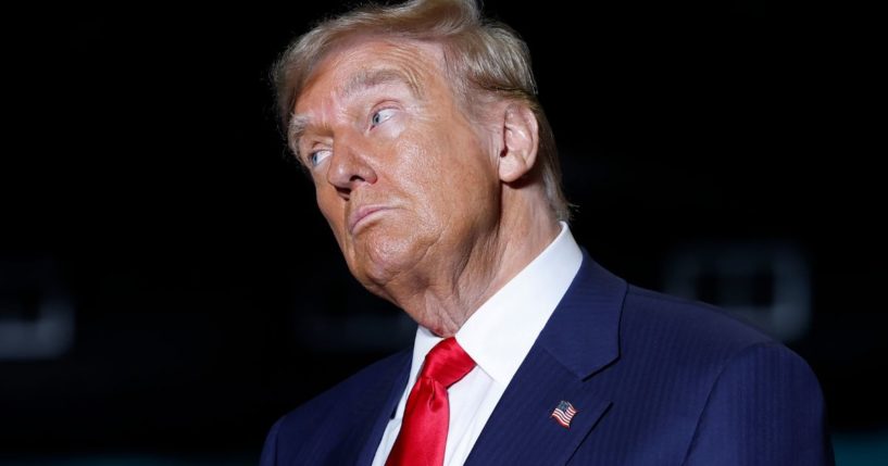 Former President Donald Trump listens as former Rep. Tulsi Gabbard speaks at a campaign rally in Greensboro, North Carolina, on Tuesday.