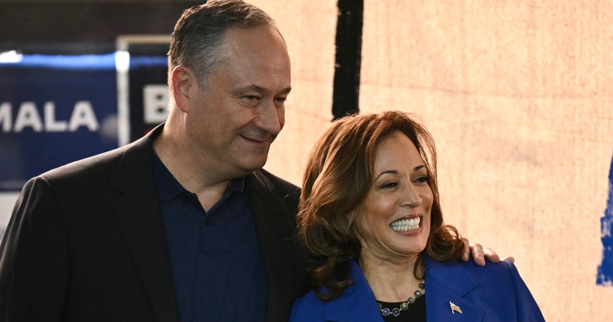 Vice President Kamala Harris, right, and second gentleman Douglas Emhoff, left, look on during a campaign event in Rochester, Pennsylvania, on Aug. 18.