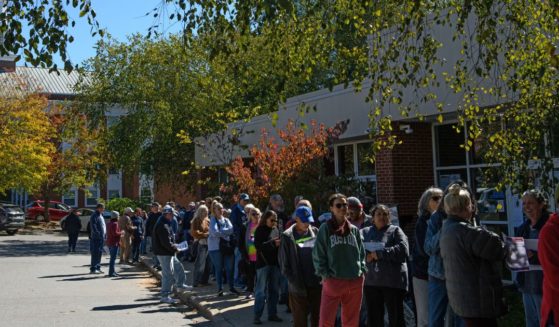 A large line of voters wait outside an early voting site Asheville, North Carolina, on Thursday.