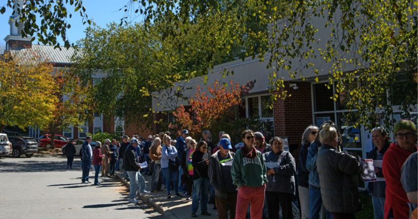 A large line of voters wait outside an early voting site Asheville, North Carolina, on Thursday.