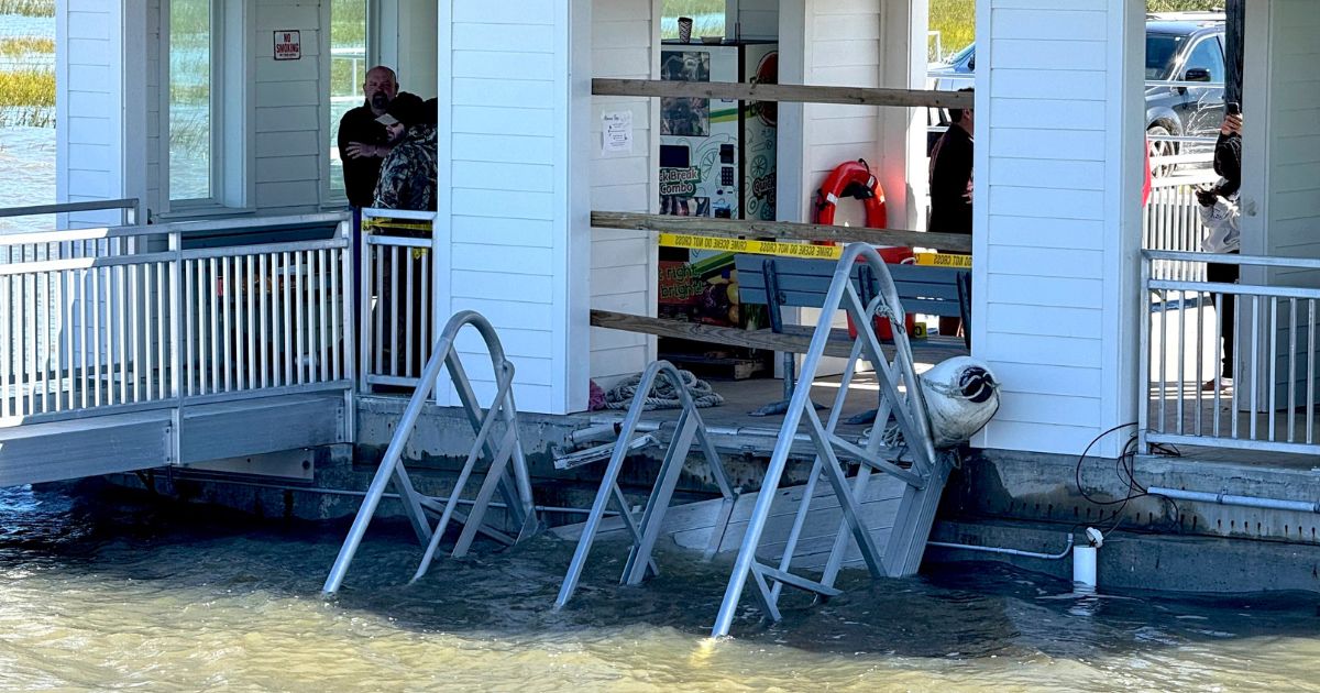 A portion of the gangway which collapsed Saturday afternoon remains visible on Sapelo Island, Georgia, on Sunday.